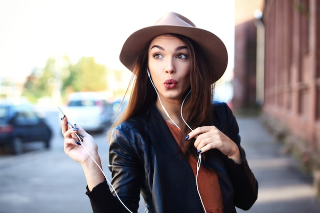 Close-up Fashion woman portrait of young pretty trendy girl posing at the city