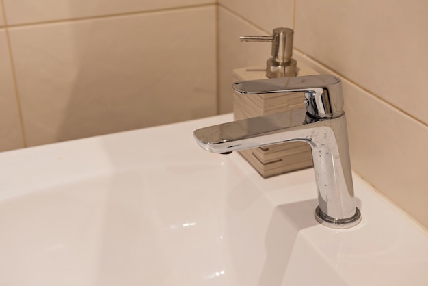 Close-up of faucet in bathroom