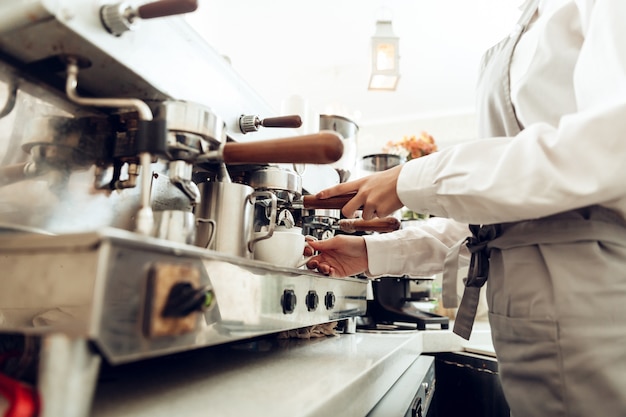 Close up of female barista preparing coffee