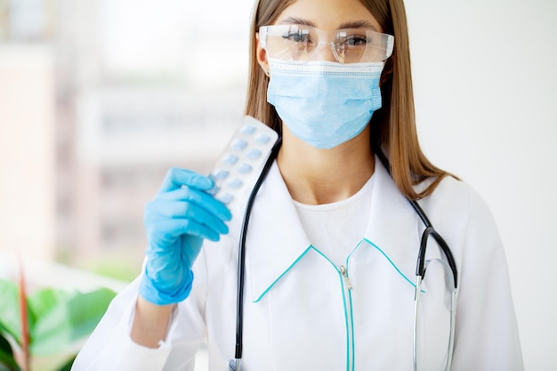 Close up of female doctor holding pill for men health