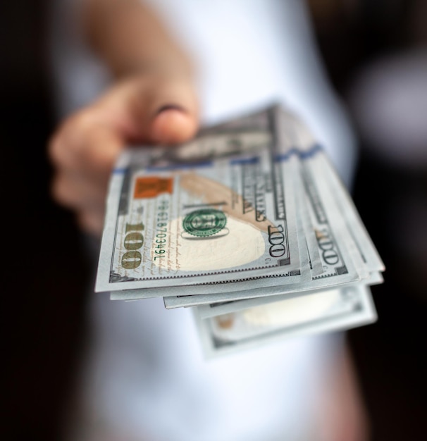 Close up female hand Counting and holding money us dollar