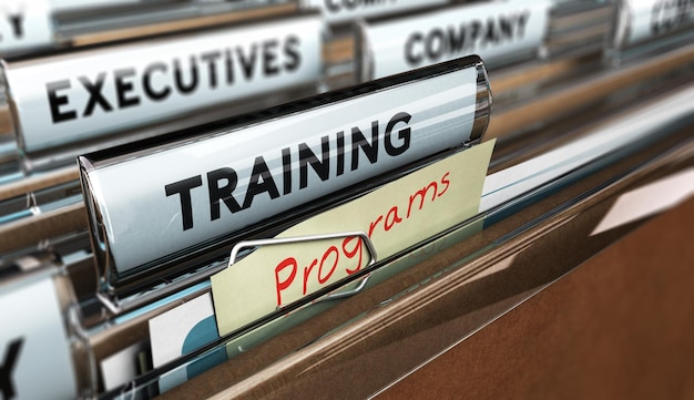 Photo close up on a file tab with the word training, focus on a yellow, note where it is hanwritten programm, blur effect. concept image for illustration of employee, training