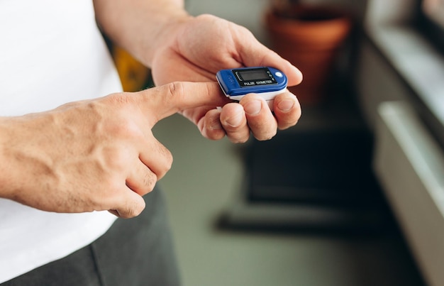 Close up of Finger and hand in an Oximeter Device Pulse oximeter