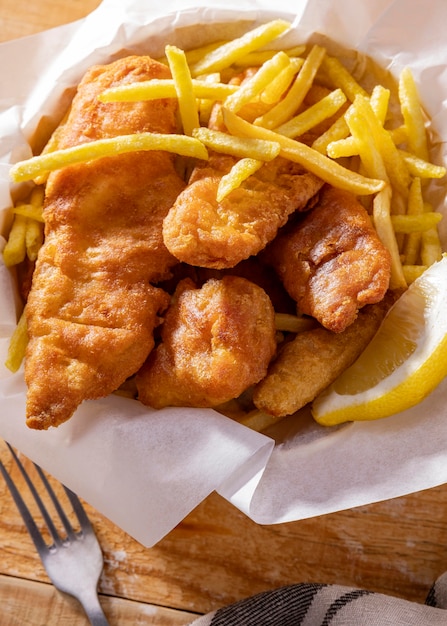 Close-up of fish and chips with lemon slice