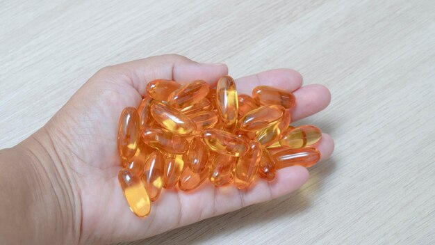 Close up of fish oil capsules on a hand