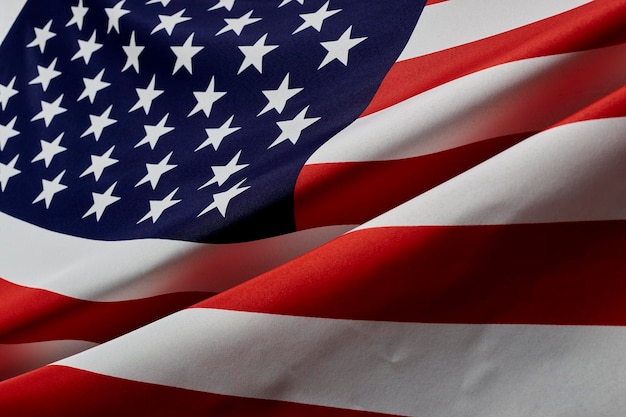 Close-up of flags against blue wall