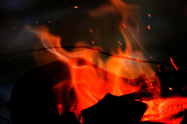 Close up flames are burning on a vintage charcoal grill