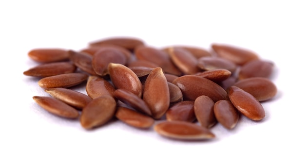 Close-up of flax seeds isolated on white background. Food