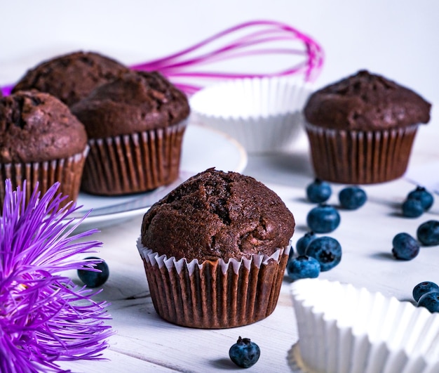 Close-up of flower and muffins on table