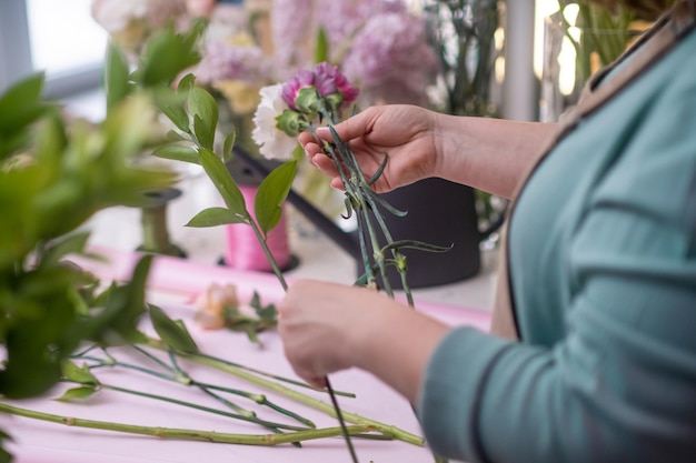 Close up flower shop owner crafts a breathtaking arrangement of pink and yellow roses flowers