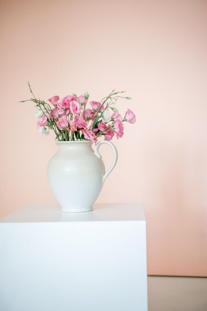 Close-up of flower vase against white wall