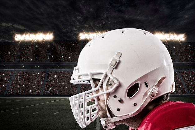 Close up of a Football Player with a red uniform on a stadium.