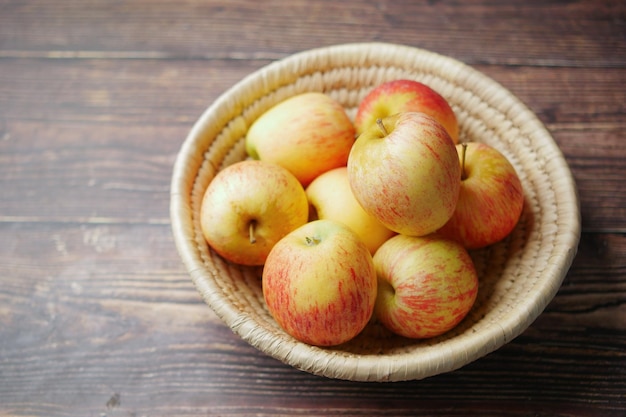 Close up of fresh apple in a bowl on wooden table