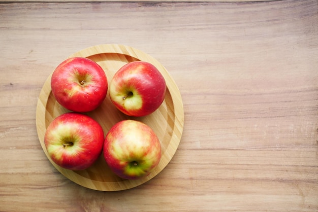 Close up of fresh apple in a bowl on wooden table