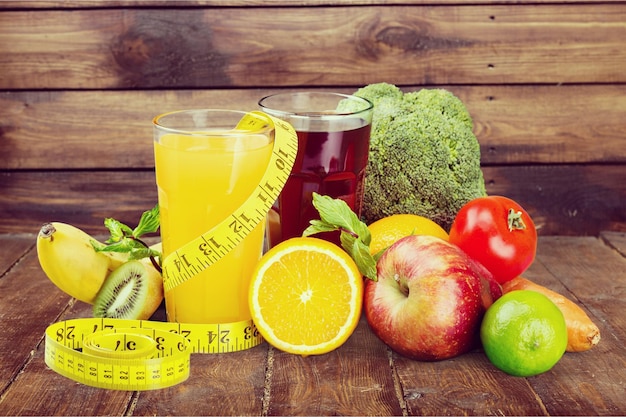 Close-up of fresh fruits with juice on wooden background