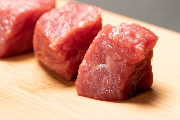 Close-up of fresh raw diced beef meat on cutting board