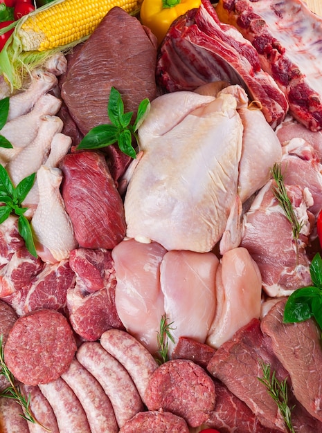 Close-up fresh raw white and red meat background with vegetables