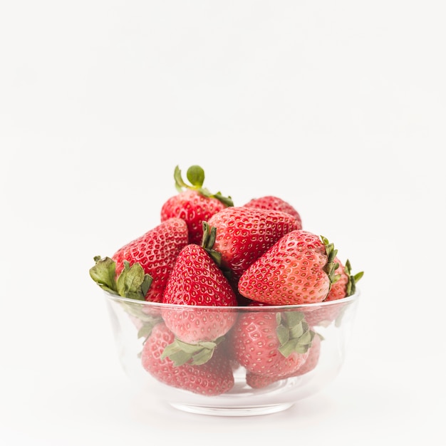 Close-up of fresh strawberries in bowl on white background