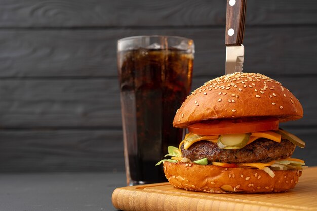 Close up  of fresh tasty burger against black table