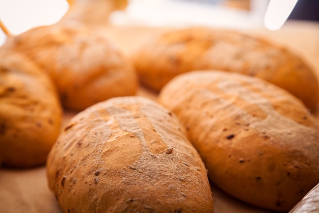 Close-up of fresh white bread in buns in a bakery, fresh loaves