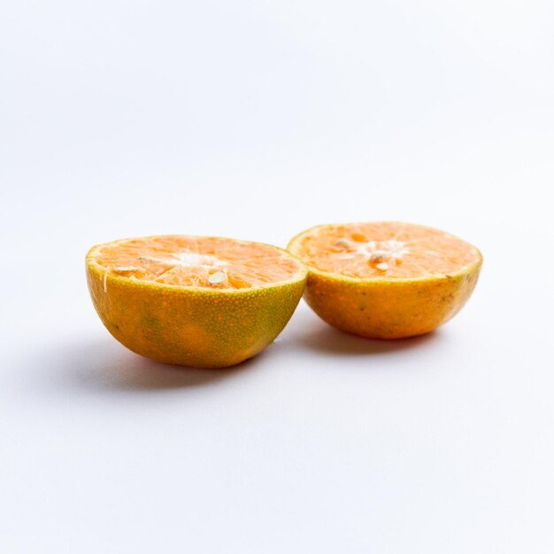 Close-up of freshly cut orange fruit isolated on white background