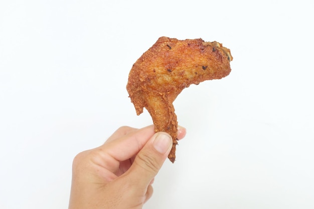 Close up a fried chicken wings in a hand isolated on white backgroundfood ideas concept