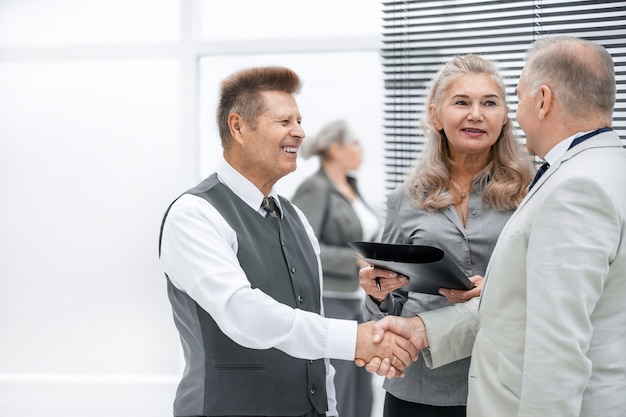 Close up. friendly business people shaking hands with each other. the concept of cooperation