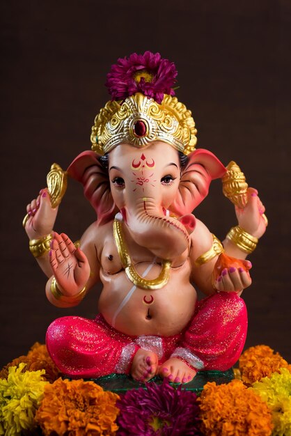 Close-up of ganesha statue against colored background