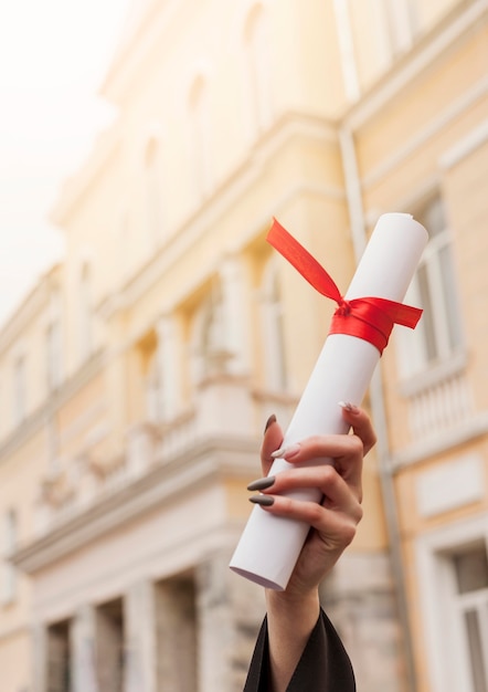 Close-up girl holding diploma