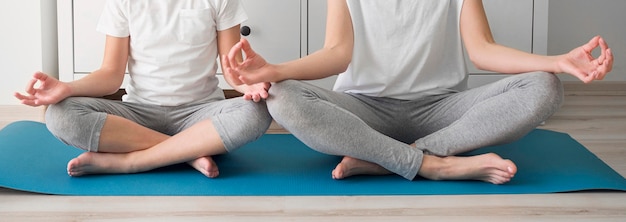 Close-up girl and mom in yoga pose