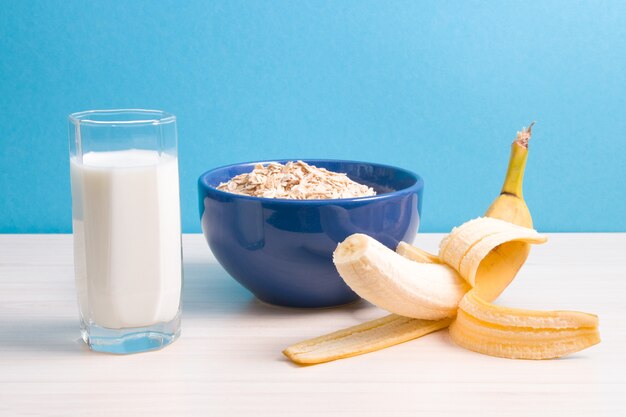 Close up glass of milk and cereals bowl