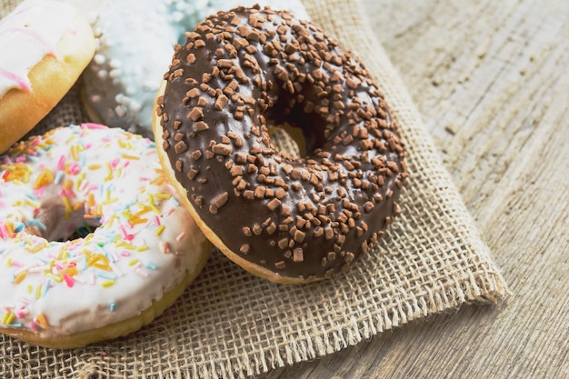 Close-up of glazed donuts on wooden background