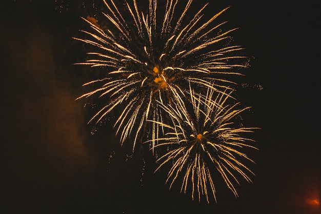 Close-up gold festive fireworks on black