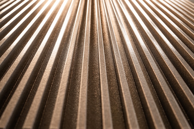 Close-up of a golden corrugated metal surface