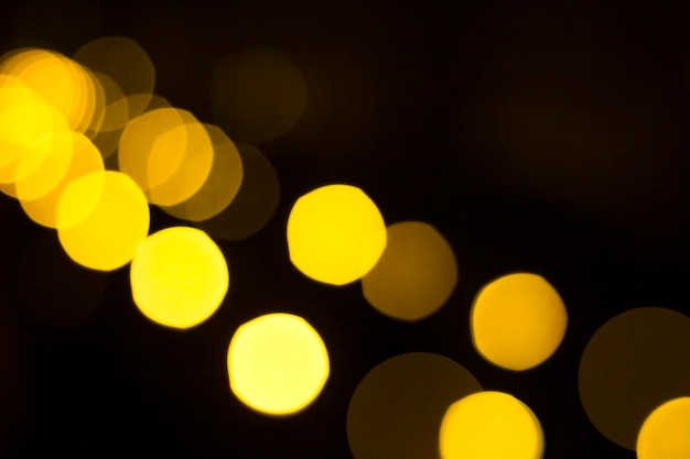 Close up of golden defocused lights on black background