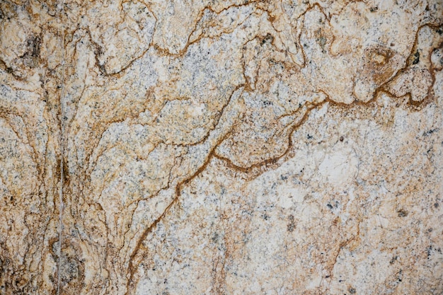 A close up of a granite with a brown and tan color.