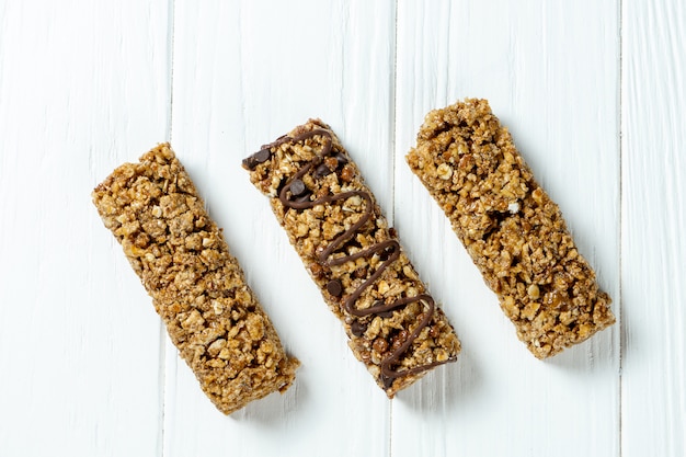 Close up on Granola Bar isolated on white wooden background.