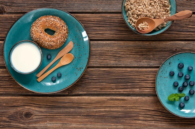 Close-up of granola with fresh berries, milk and donuts. 