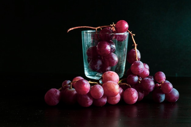 Close-up of grapes in glass container on table