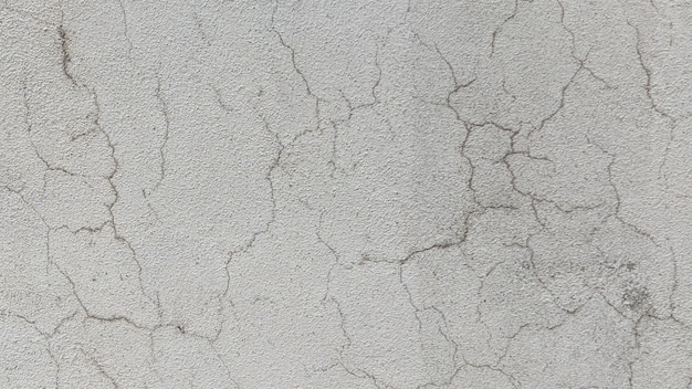 A close up of a gray textured wall with a rough textured surface.