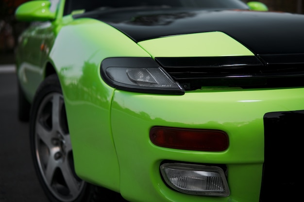 Close up of green and black sport car. Japanese oldtimer.