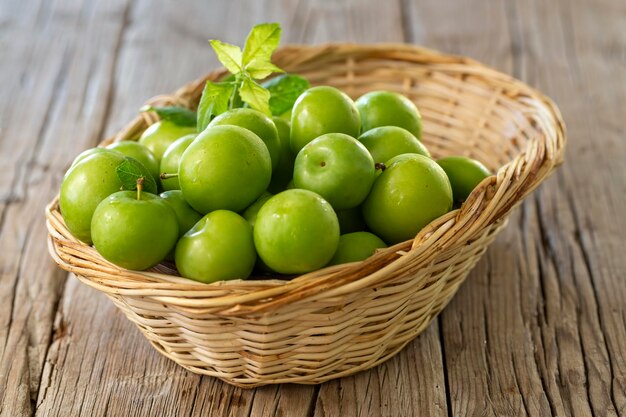 Photo close up of green plums or greengage in a basket