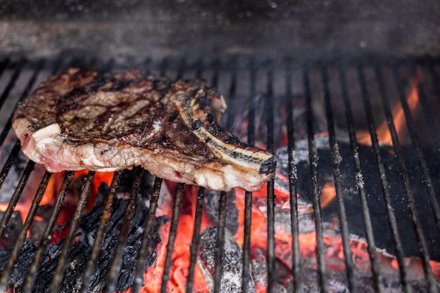 Close-up of a grilled beef rib on a barbecue grill