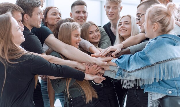 Close up a group of young people showing their unity