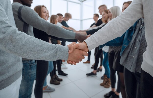 Close up groups of young business people shaking hands