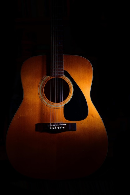 Photo close-up of guitar against black background