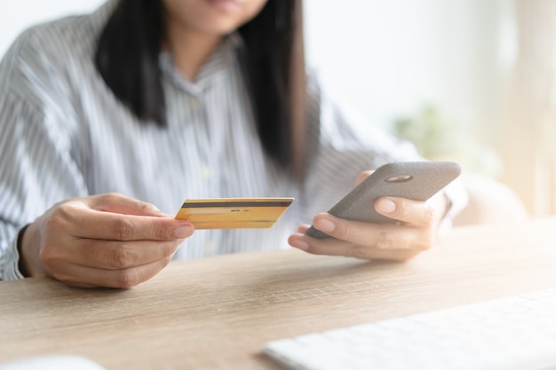 Close up hand of Asian women are buying online with a credit card.