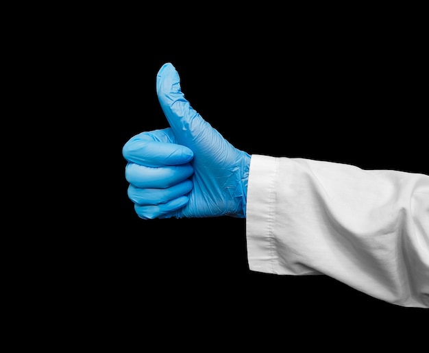 Close-up of a hand in a blue glove showing a thumbs up