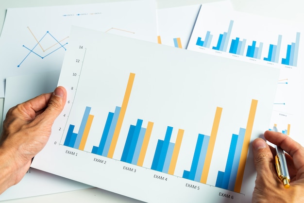 Close up hand of business man with financial report accounting analysis.