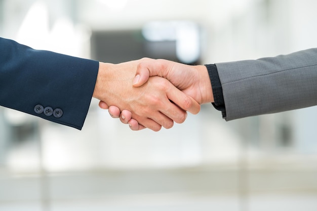 Close-up hand of Businessman handshake for teamwork of business merger partnership and business deal,successful negotiate,hand shake